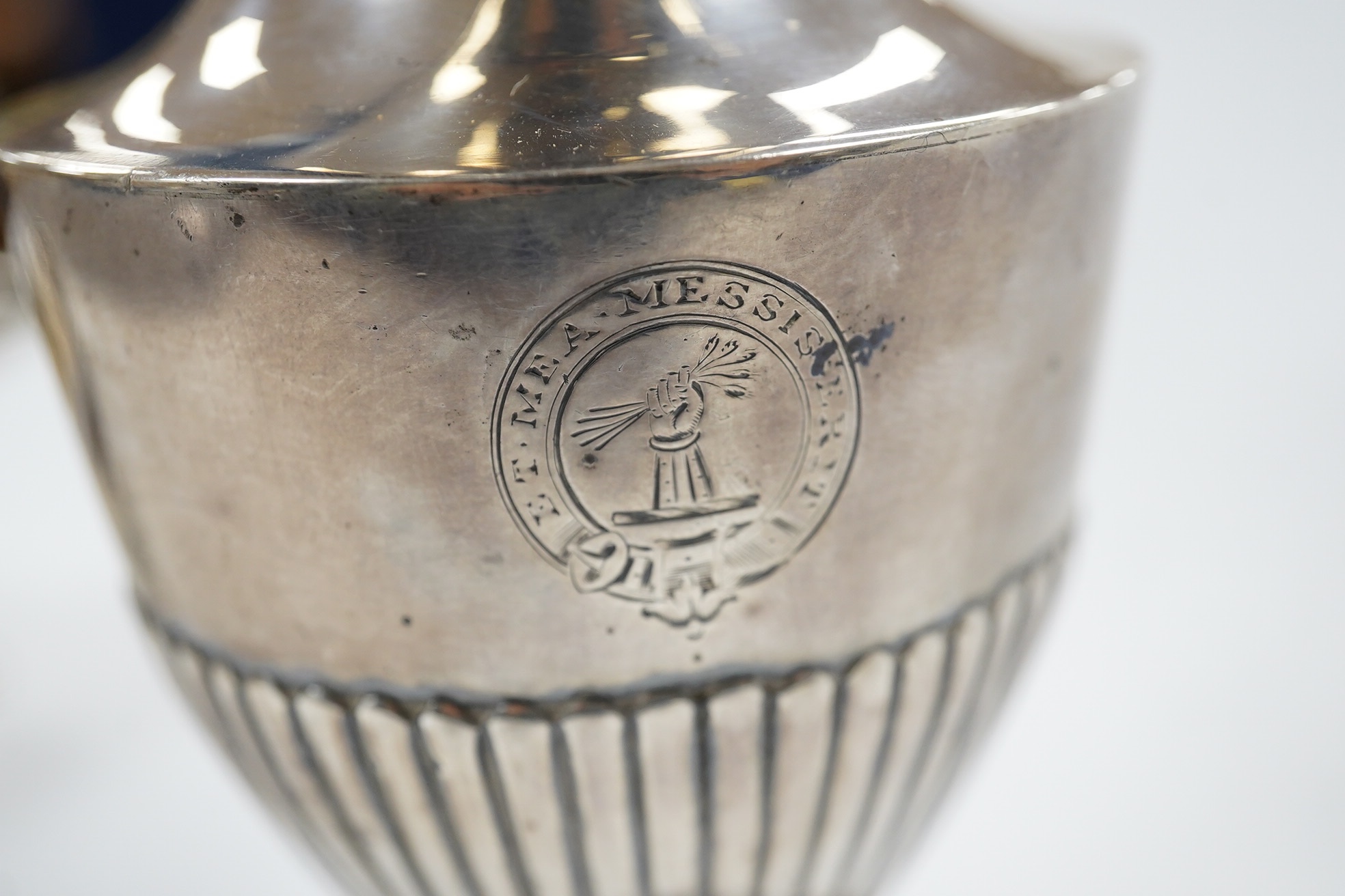 A George II small silver sauceboat, Gwillim & Castle, London, 1744, length 13.6cm, together with a George III silver hot water jug, London, 1791, gross 9.6oz. Condition - poor